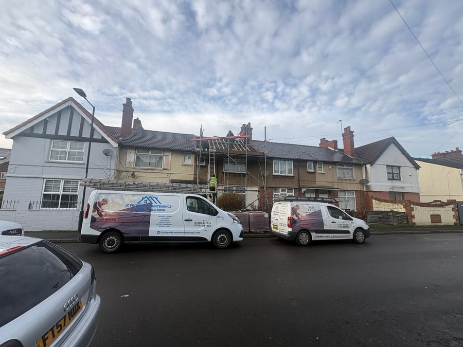 JC Property Maintenance vans parked outside terraced houses with scaffolding