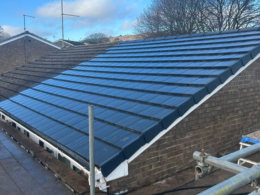 Newly tiled pitched roof on a brick property