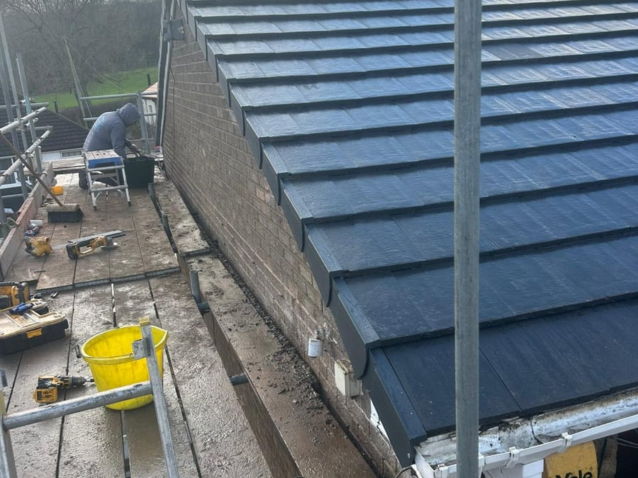 Roof work in progress with tools on the scaffold platform